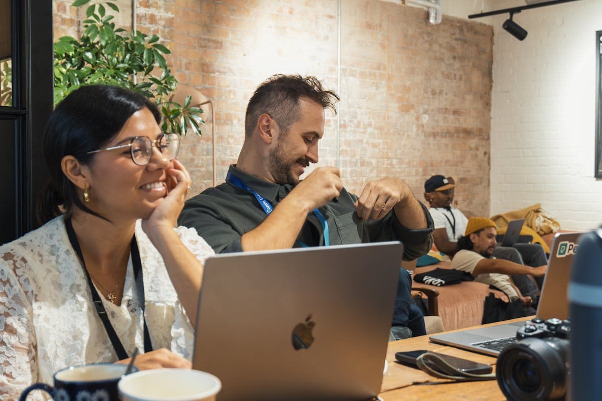 IT team gathered around a laptop during an operations review