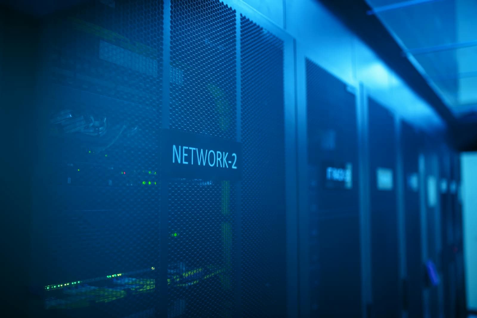 Blue-lit network rack and server equipment in a server room