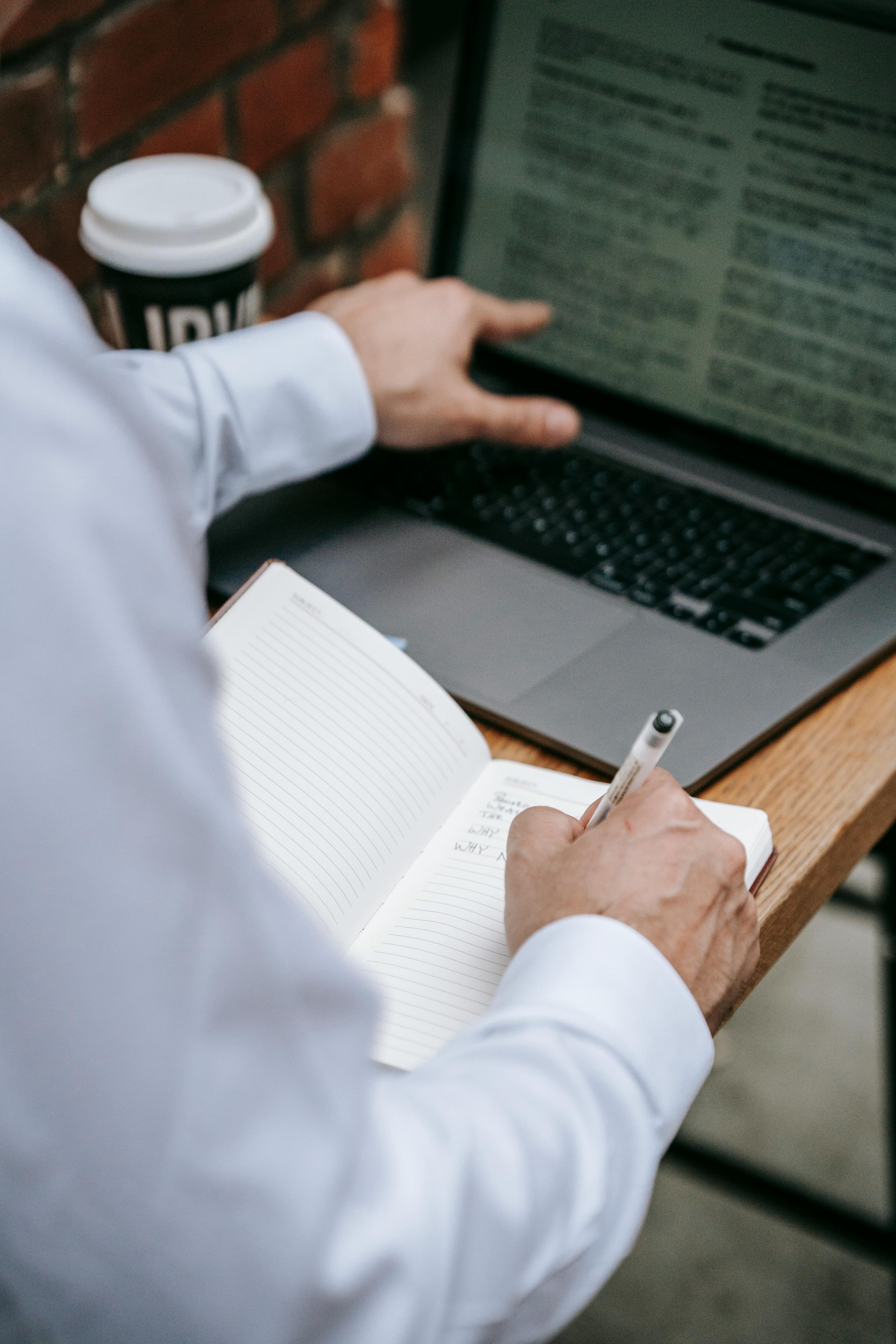 Person working at a laptop used for an article about Windows Server hotpatch maintenance planning