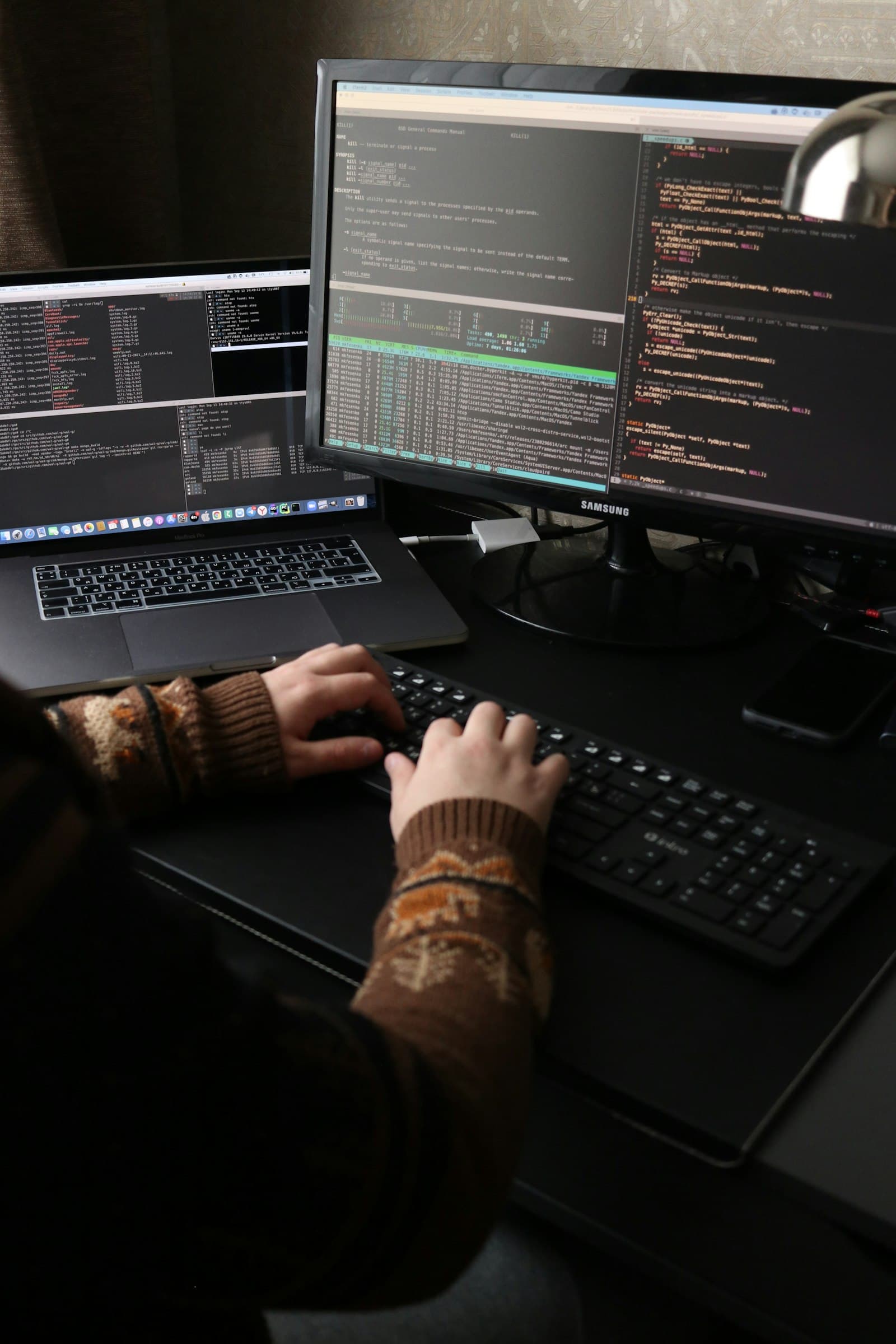 Administrator workstation with terminal and monitoring windows open across several screens